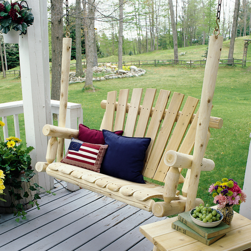 Lakeland mills cedar log porch swing set in an open garden
